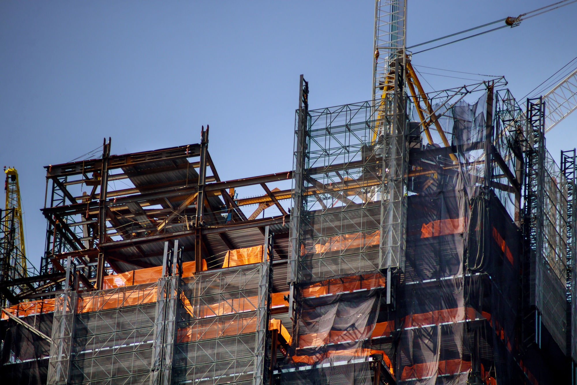 Construction work site residential lots of tower construction site with cranes and building with bl Construction work site residential lots of tower construction site with cranes and building with bl