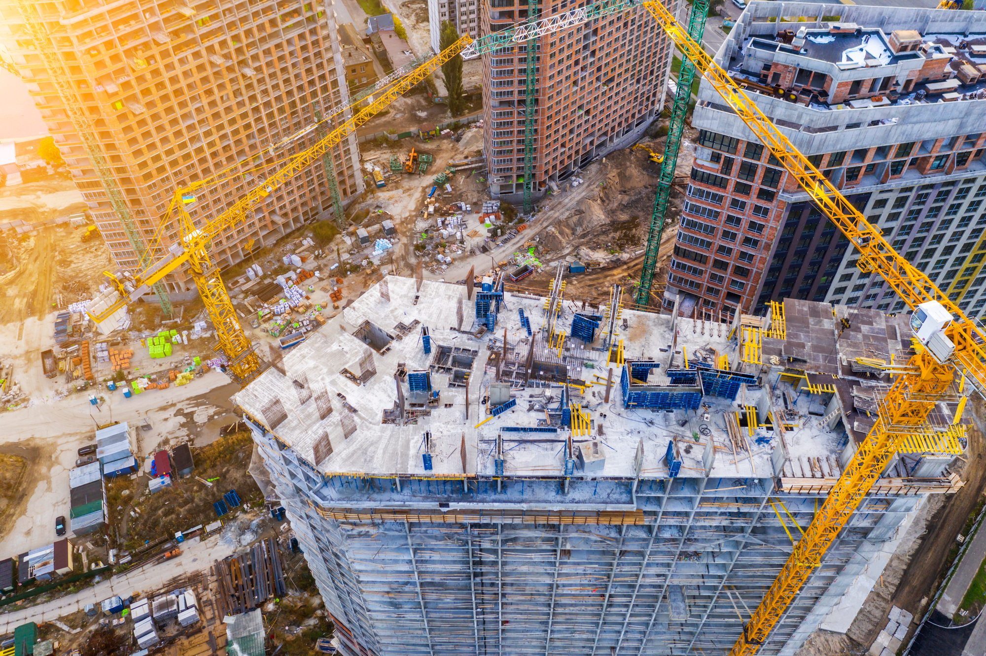 Construction site with cranes at sunset. Construction of an apartment building